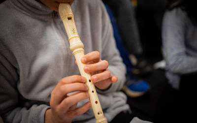 Student playing a recorder 